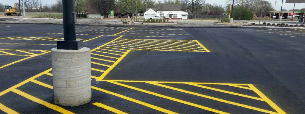 A commercial parking lot with yellow striping in Kent